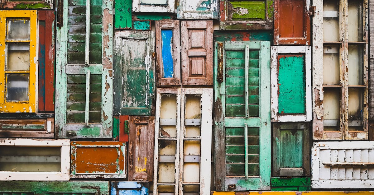 A vivid collection of old, weathered window frames creating a rustic texture background.