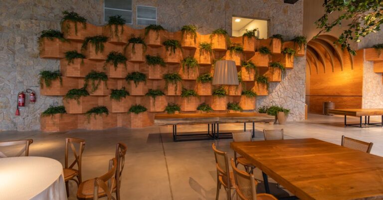 Stylish interior with wooden tables and a vibrant vertical green wall design.